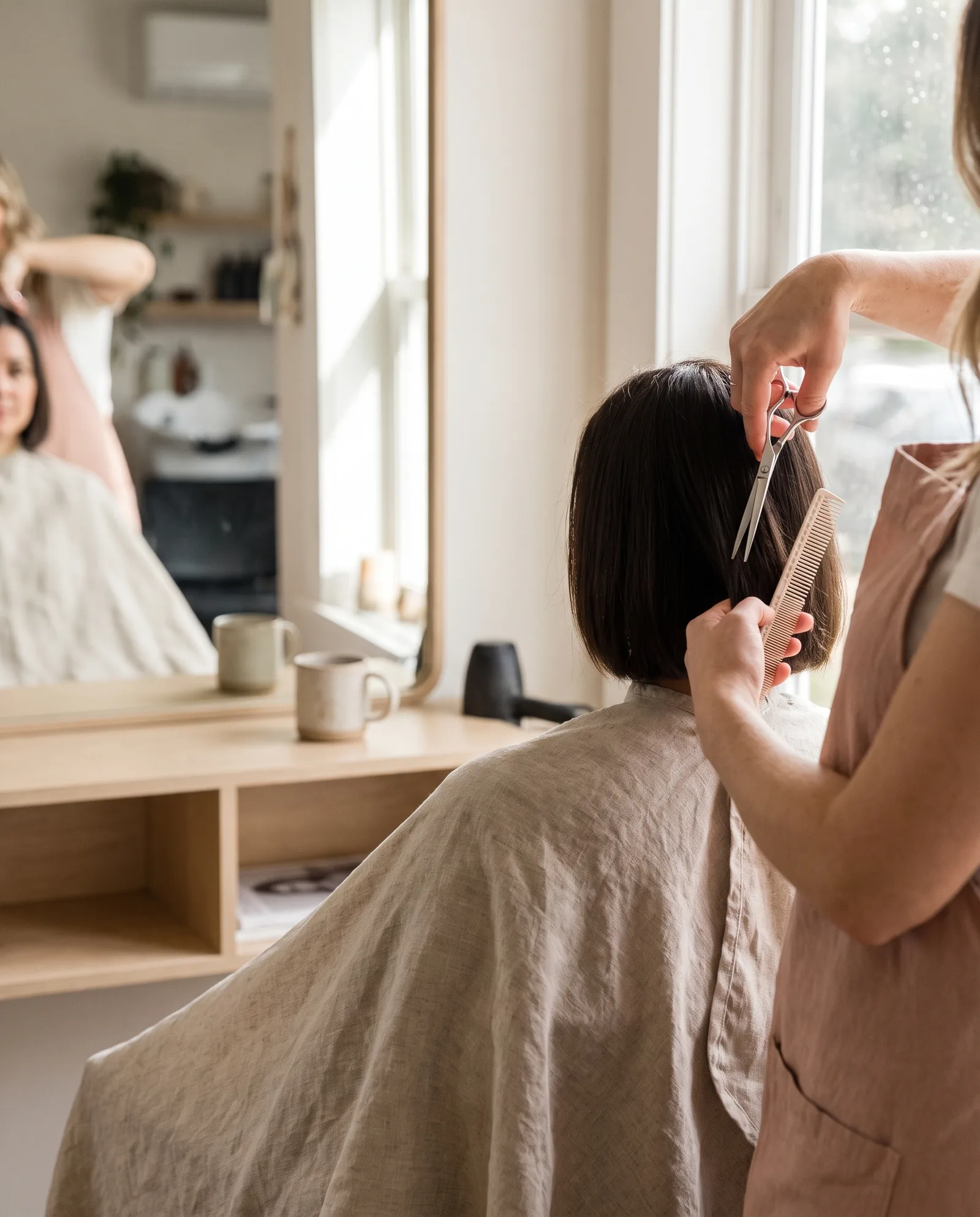 Stylist cutting a sleek chin-length bob